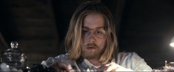 Movie still from “Evil Dead” (2013), directed by Fede Alvarez – A person with long hair wearing glasses; Close Up shot, Low angle