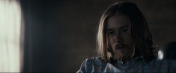 Movie still from “Evil Dead” (2013), directed by Fede Alvarez – A person with long hair; Close Up shot, Over the shoulder angle