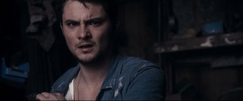 Movie still from “Evil Dead” (2013), directed by Fede Alvarez – A person wearing a jacket; Close Up shot, Over the shoulder angle