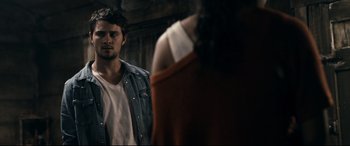 Movie still from “Evil Dead” (2013), directed by Fede Alvarez – A man standing next to a woman in a room; Medium shot, Over the shoulder angle