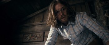 Movie still from “Evil Dead” (2013), directed by Fede Alvarez – A man with long brown hair wearing glasses; Medium shot, Low angle