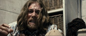 Movie still from “Evil Dead” (2013), directed by Fede Alvarez – A person with blood on their face; Close Up shot, Over the shoulder angle