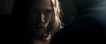 Movie still from “Evil Dead” (2013), directed by Fede Alvarez – A person with long hair and a beard; Close Up shot, Over the shoulder angle