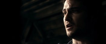 Movie still from “Evil Dead” (2013), directed by Fede Alvarez – A man's face in the dark; Close Up shot, Over the shoulder angle