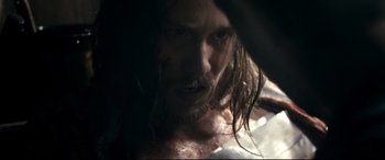 Movie still from “Evil Dead” (2013), directed by Fede Alvarez – A person with long hair; Close Up shot, Over the shoulder angle