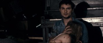Movie still from “Evil Dead” (2013), directed by Fede Alvarez – A man and a woman are holding each other in a dark room; Close Up shot, Over the shoulder angle