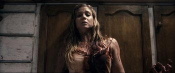 Movie still from “Evil Dead” (2013), directed by Fede Alvarez – A woman with blood all over her body; Medium shot, Overhead angle