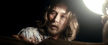 Movie still from “Evil Dead” (2013), directed by Fede Alvarez – A person with long hair; Close Up shot, Overhead angle