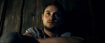 Movie still from “Evil Dead” (2013), directed by Fede Alvarez – A person with his arms crossed; Close Up shot, Low angle