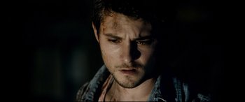 Movie still from “Evil Dead” (2013), directed by Fede Alvarez – A person wearing a jean shirt; Close Up shot, Over the shoulder angle