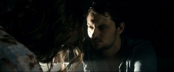 Movie still from “Evil Dead” (2013), directed by Fede Alvarez – A man and a woman in a dark room; Close Up shot, Over the shoulder angle