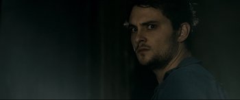 Movie still from “Evil Dead” (2013), directed by Fede Alvarez – A person looking at the camera; Close Up shot, Over the shoulder angle