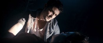 Movie still from “Evil Dead” (2013), directed by Fede Alvarez – A man looking down at a woman in the dark; Close Up shot, Overhead angle