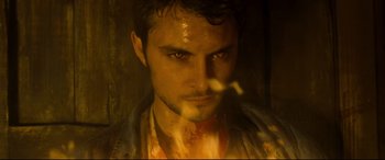Movie still from “Evil Dead” (2013), directed by Fede Alvarez – A person with a knife in his mouth; Close Up shot, High angle
