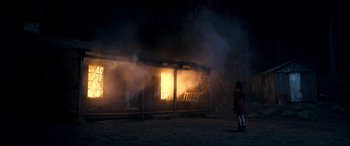 Movie still from “Evil Dead” (2013), directed by Fede Alvarez – A woman standing in front of a burning house; Extreme Wide shot, Low angle