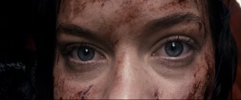 Movie still from “Evil Dead” (2013), directed by Fede Alvarez – A woman's eyes with brown makeup; Extreme Close Up shot, Overhead angle