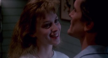 Movie still from “Evil Dead II” (1987), directed by Sam Raimi – A man and a woman smiling at each other; Close Up shot, Over the shoulder angle