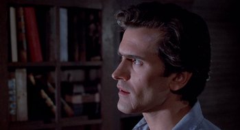 Movie still from “Evil Dead II” (1987), directed by Sam Raimi – A person looking to his left; Close Up shot, Low angle
