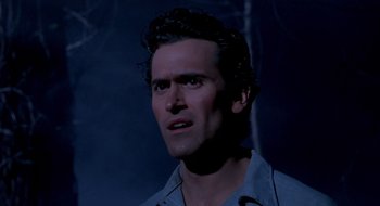 Movie still from “Evil Dead II” (1987), directed by Sam Raimi – A person wearing a blue shirt; Close Up shot, Low angle