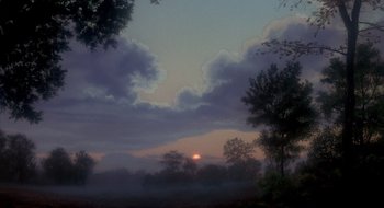 Movie still from “Evil Dead II” (1987), directed by Sam Raimi – The sun is setting on a cloudy day; Extreme Wide shot, Low angle
