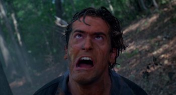 Movie still from “Evil Dead II” (1987), directed by Sam Raimi – A person with mud all over his face; Close Up shot, Overhead angle