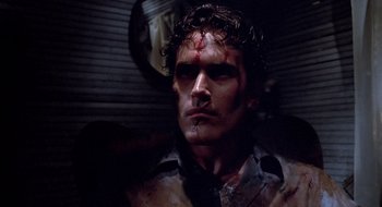 Movie still from “Evil Dead II” (1987), directed by Sam Raimi – A person with blood all over his face; Close Up shot, Low angle