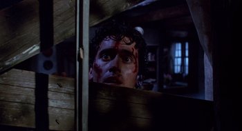Movie still from “Evil Dead II” (1987), directed by Sam Raimi – A person with blood on their face; Close Up shot, Low angle