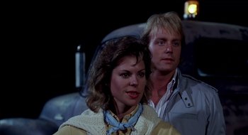 Movie still from “Evil Dead II” (1987), directed by Sam Raimi – A man and a woman sitting next to each other in a car; Close Up shot, Low angle