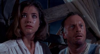 Movie still from “Evil Dead II” (1987), directed by Sam Raimi – A man and a woman looking at the camera; Close Up shot, Low angle