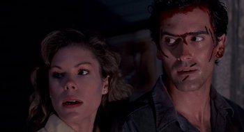 Movie still from “Evil Dead II” (1987), directed by Sam Raimi – A man and a woman with blood on their faces; Close Up shot, Low angle