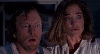 Movie still from “Evil Dead II” (1987), directed by Sam Raimi – A man and a woman looking surprised at the camera; Close Up shot, Low angle
