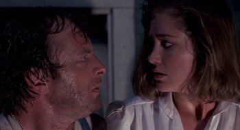 Movie still from “Evil Dead II” (1987), directed by Sam Raimi – A man and a woman looking at one another; Close Up shot, Over the shoulder angle