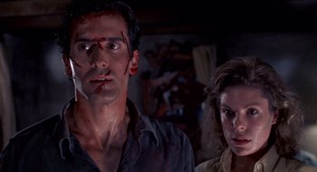 Movie still from “Evil Dead II” (1987), directed by Sam Raimi – A man and a woman with blood on their faces; Close Up shot, Low angle