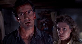 Movie still from “Evil Dead II” (1987), directed by Sam Raimi – A man and a woman with blood all over their faces; Close Up shot, Low angle