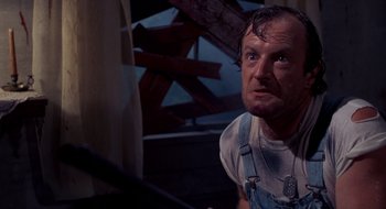 Movie still from “Evil Dead II” (1987), directed by Sam Raimi – A person wearing a shirt and tie; Close Up shot, Low angle
