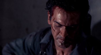 Movie still from “Evil Dead II” (1987), directed by Sam Raimi – A person with blood on his face; Close Up shot, Low angle