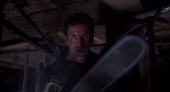 Movie still from “Evil Dead II” (1987), directed by Sam Raimi – A person with a sword; Close Up shot, Low angle