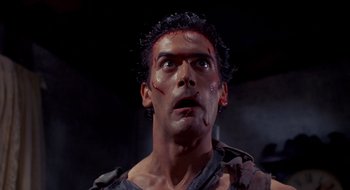 Movie still from “Evil Dead II” (1987), directed by Sam Raimi – A person with blood on his face; Close Up shot, Low angle