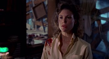 Movie still from “Evil Dead II” (1987), directed by Sam Raimi – A person wearing a dress shirt; Close Up shot, Low angle