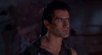 Movie still from “Evil Dead II” (1987), directed by Sam Raimi – A man's face with blood on his face; Close Up shot, Low angle
