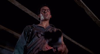 Movie still from “Evil Dead II” (1987), directed by Sam Raimi – A person holding a gun in a dark room; Medium shot, Low angle