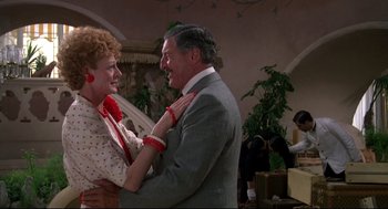 Movie still from “Evil Under the Sun” (1982), directed by Guy Hamilton – An older man and a woman dancing in a room; Medium shot, Over the shoulder angle