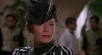 Movie still from “Evil Under the Sun” (1982), directed by Guy Hamilton – A person wearing a hat with a veil; Close Up shot, Low angle