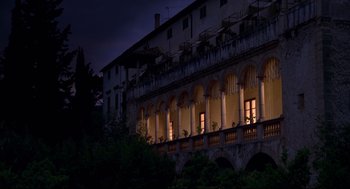 Movie still from “Evil Under the Sun” (1982), directed by Guy Hamilton – A building that has been lit up at night time; Extreme Wide shot, Low angle