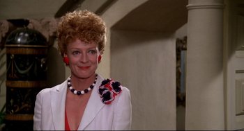 Movie still from “Evil Under the Sun” (1982), directed by Guy Hamilton – A person wearing a suit and tie; Close Up shot, Over the shoulder angle