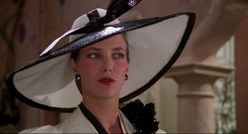 A woman wearing a white hat with a black ribbon around it's brim