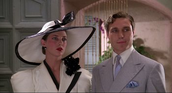Movie still from “Evil Under the Sun” (1982), directed by Guy Hamilton – A man and a woman wearing hats and suits; Close Up shot, Low angle