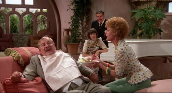 Movie still from “Evil Under the Sun” (1982), directed by Guy Hamilton – An older man sitting in front of two women; Wide shot, Over the shoulder angle