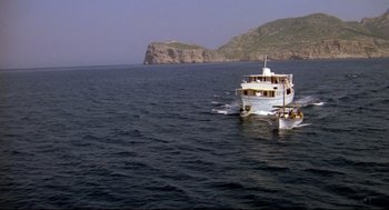 A white boat floating on top of a large body of water