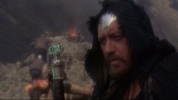 Movie still from “Excalibur” (1981), directed by John Boorman – A person with a sword; Close Up shot, Over the shoulder angle